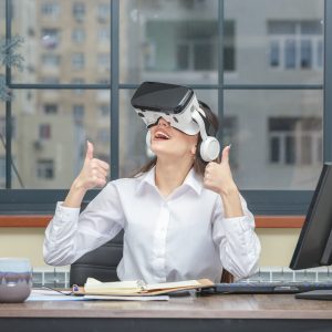 Photo of young lady wearing VR device and gesture thumbs up. High quality photo